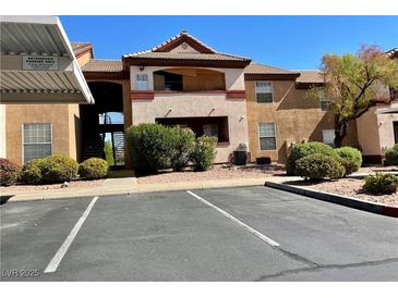 Inviting condo complex with well-maintained landscaping, numbered parking spots, and a covered entry way at 231 W Horizon Ridge Pkwy # 514, Henderson, NV 89012