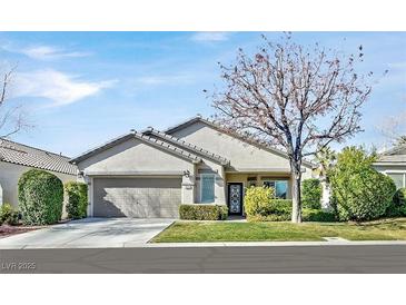 Charming single-story home with a well-manicured front yard and a two-car garage at 2597 Belgreen St, Las Vegas, NV 89135