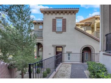 Charming home features a private entry with wrought iron details and landscaped walkway at 41 Via Verso Lago, Henderson, NV 89011