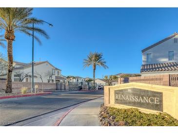 A well maintained Renaissance community entrance with lush desert landscaping and palm trees at 4833 Integrity St, North Las Vegas, NV 89031