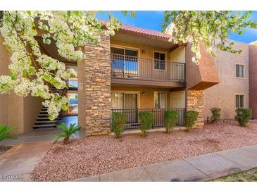 Charming two-story condo featuring stone accents, a cozy balcony, and well-maintained landscaping at 5060 Indian River Dr # 382, Las Vegas, NV 89103