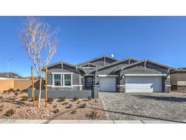 Charming single-story home with a stone-accented facade and a paved driveway to a two-car garage at 510 Copper Falcon Ave, Henderson, NV 89011