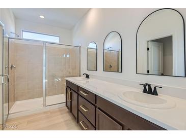 Modern bathroom featuring a double vanity, sleek fixtures, and a glass-enclosed shower at 5606 Spring Trellis St, Las Vegas, NV 89113