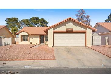 Charming single-story home featuring desert landscaping, an attached two-car garage, and a red tile roof at 6130 Desert Sun Dr, Las Vegas, NV 89110