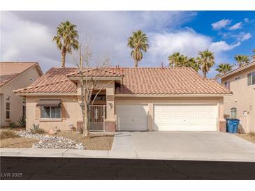 Charming single-story home featuring a tile roof, well-manicured landscaping, and a spacious two-car garage at 8736 Vista Ladera Ct, Las Vegas, NV 89147