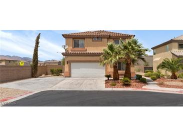 Two-story home featuring a two-car garage, desert landscaping and tile roof at 9792 Valmeyer Ave, Las Vegas, NV 89148