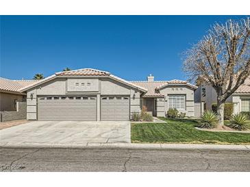 Charming single-story home with a three-car garage and well-maintained front yard at 1110 Legato Dr, Las Vegas, NV 89123