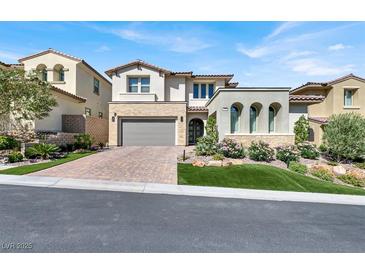 Stunning two-story home with a brick driveway and meticulously landscaped front yard at 12054 Portamento Ct, Las Vegas, NV 89138