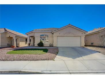 Charming single-story home featuring a well-maintained front yard and attached two-car garage at 1421 Hometown Ave, Henderson, NV 89074