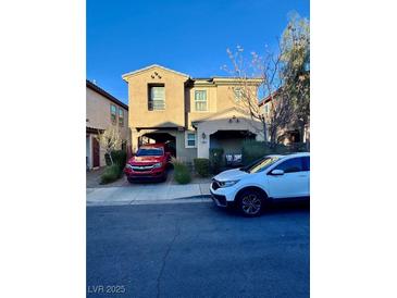 Charming two-story townhome featuring a covered carport and inviting front porch area at 156 Belmont Canyon Pl, Henderson, NV 89015