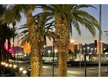 Beautiful city skyline view with palm trees lining the street at dusk at 1701 E Katie Ave # 42, Las Vegas, NV 89119