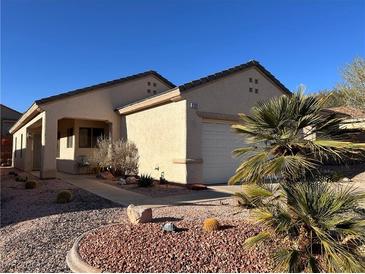 Charming single-story home featuring desert landscaping, a two-car garage, and a covered front porch at 2201 Tiger Links Dr, Henderson, NV 89012