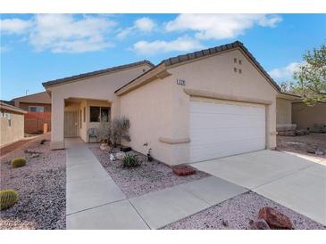 Charming single-story home featuring a two-car garage, low maintenance desert landscaping, and a welcoming front entry at 2201 Tiger Links Dr, Henderson, NV 89012