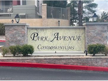 Park Avenue Condominiums building sign with brick accents and lush green landscaping at 27 E Agate Ave # 303, Las Vegas, NV 89123