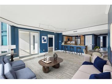 Open-concept living room with a modern kitchen, balcony access, and stylish contemporary furnishings at 322 Karen Ave # 2501, Las Vegas, NV 89109