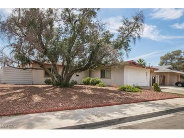 Charming single-story home featuring a spacious front yard with mature trees providing ample shade at 4409 Cinderella Ln, Las Vegas, NV 89102