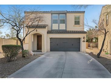 Charming two-story home with a well-manicured lawn and a two-car garage at 511 Via Ripagrande Ave, Henderson, NV 89011