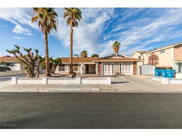 Charming single-story home featuring desert landscaping, palm trees, and a spacious driveway at 6202 La Palma Pkwy, Las Vegas, NV 89118