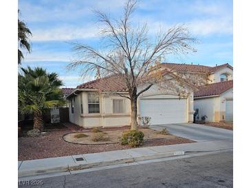 Charming single-story home with desert landscaping and a two-car garage at 7186 Cressida Ct, Las Vegas, NV 89113