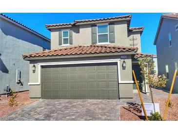 Two-story home featuring a two-car garage, well-maintained landscaping, and a red tile roof at 7246 Copper Grove Ave, Las Vegas, NV 89113