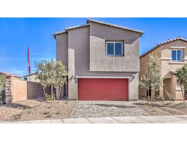 Modern two-story home boasts a red garage door, desert landscaping, and concrete driveway at 804 Ruby Sedona Ave # Lot 152, North Las Vegas, NV 89081