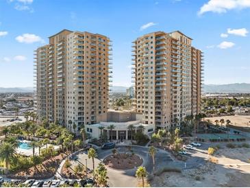 An aerial view of the luxury high-rise with a resort-style pool, landscaping and surrounding city views at 8255 Las Vegas Blvd # 610, Las Vegas, NV 89123