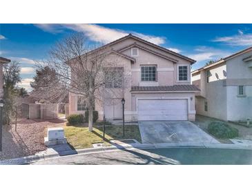 Charming two-story home features a well-maintained lawn and a two-car garage at 9879 Jazzy June St, Las Vegas, NV 89183