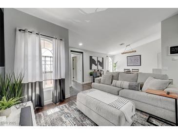 Comfortable living room with gray couch, ottoman, decorative pillows, and nice decor and a large window for lots of natural light at 1800 Edmond St # 215, Las Vegas, NV 89146