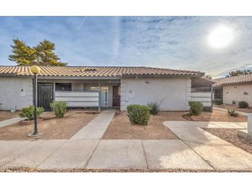 Charming single-story home with low-maintenance landscaping and a tile roof under a sunny sky at 211 N Lamb Blvd # C, Las Vegas, NV 89110