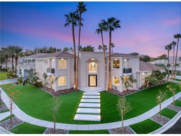 Stunning two-story home with manicured lawn, palm trees, and modern walkway leading to the front door at 2293 Buckingham Ct, Henderson, NV 89074