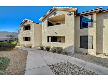 Exterior view of a two-story building with a red tile roof and beige stucco walls at 2451 N Rainbow Blvd # 2076, Las Vegas, NV 89108