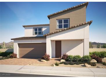 Modern two-story home with desert landscaping, attached garage, and stylish architectural details at 310 La Musica Pl, Henderson, NV 89015