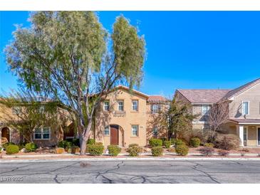 Charming two-story home with a well-manicured front yard and mature trees, featuring a warm and inviting exterior at 3204 Romanesque Art Ave, Henderson, NV 89044