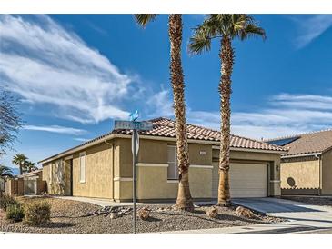 Charming single-story home with desert landscaping, tile roof, and palm trees in a sunny neighborhood at 6035 Eganridge Ct, North Las Vegas, NV 89081