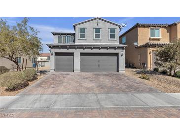 Two-story home featuring a two-car garage and brick driveway at 6832 Upland Heights Ave, Las Vegas, NV 89142