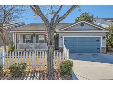 Charming single-story home featuring a well-manicured yard, picket fence, and attached garage at 7835 Meandering Path Ave, Las Vegas, NV 89131