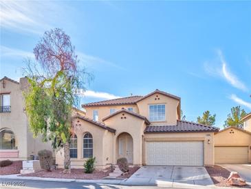 Charming two-story home features stucco siding, a tile roof, and a well-manicured front yard, and a two car garage at 10383 Gwynns Falls St, Las Vegas, NV 89183