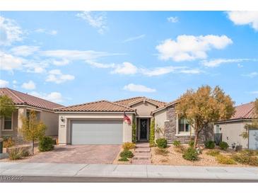 Charming single-story home with stone accents, a tile roof, and a well-manicured front yard at 10438 Skye Arroyo Ave, Las Vegas, NV 89166