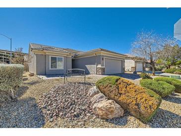 Charming single-story home featuring desert landscaping and a welcoming two-car garage at 2705 Cuckoo Shrike Ave, North Las Vegas, NV 89084
