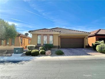 Charming single-story home featuring a tile roof, desert landscaping, and an attached two car garage at 37 Buffalo Gap Ct, North Las Vegas, NV 89084