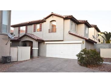 Inviting two-story home featuring a two-car garage and well-maintained landscaping at 10596 Corte Sierra St, Las Vegas, NV 89183