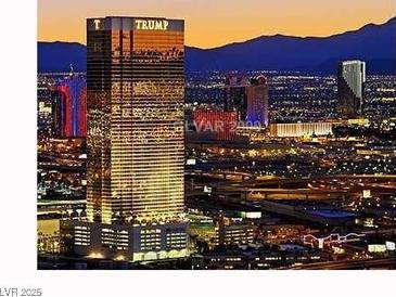 Illuminated Las Vegas cityscape featuring the Trump hotel set against a backdrop of mountains at twilight at 2000 N Fashion Show Dr # 4722, Las Vegas, NV 89109