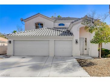 Charming two-story home with a three-car garage, gated entry, and well-maintained landscaping at 21 Bridal Falls Ct, Las Vegas, NV 89148