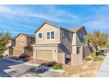 Charming two-story home featuring a tan stucco exterior, attached garage, and low-maintenance landscaping at 2300 Trasimeno Pl, Henderson, NV 89044