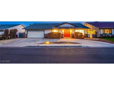 Charming single-story home featuring a well-manicured front yard and a welcoming red front door at 3057 Downing Pl, Las Vegas, NV 89121