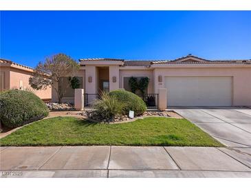 Charming single-story home featuring a well-manicured lawn, desert landscaping, and an attached two-car garage at 328 Vineyard Ln, Mesquite, NV 89027