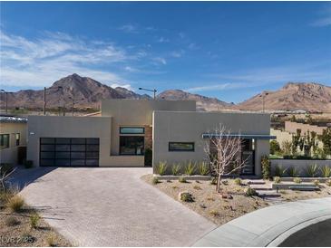 Modern home showcasing desert landscaping and mountain views under a bright, cloudy sky at 333 Highview Ridge Ave, Las Vegas, NV 89138