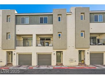 Modern townhome showcasing a gray garage, balcony, neutral stucco, and contemporary design at 3772 Brilliant Sunset St, Las Vegas, NV 89129