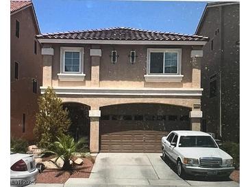 Charming two-story home with a desert landscape and beautiful desert colors and a two-car garage at 5320 Tartan Hill Ave, Las Vegas, NV 89141