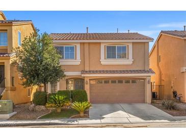 Charming two-story home featuring a well-manicured front yard and a convenient two-car garage at 5971 Sonoma Station Ave, Las Vegas, NV 89139